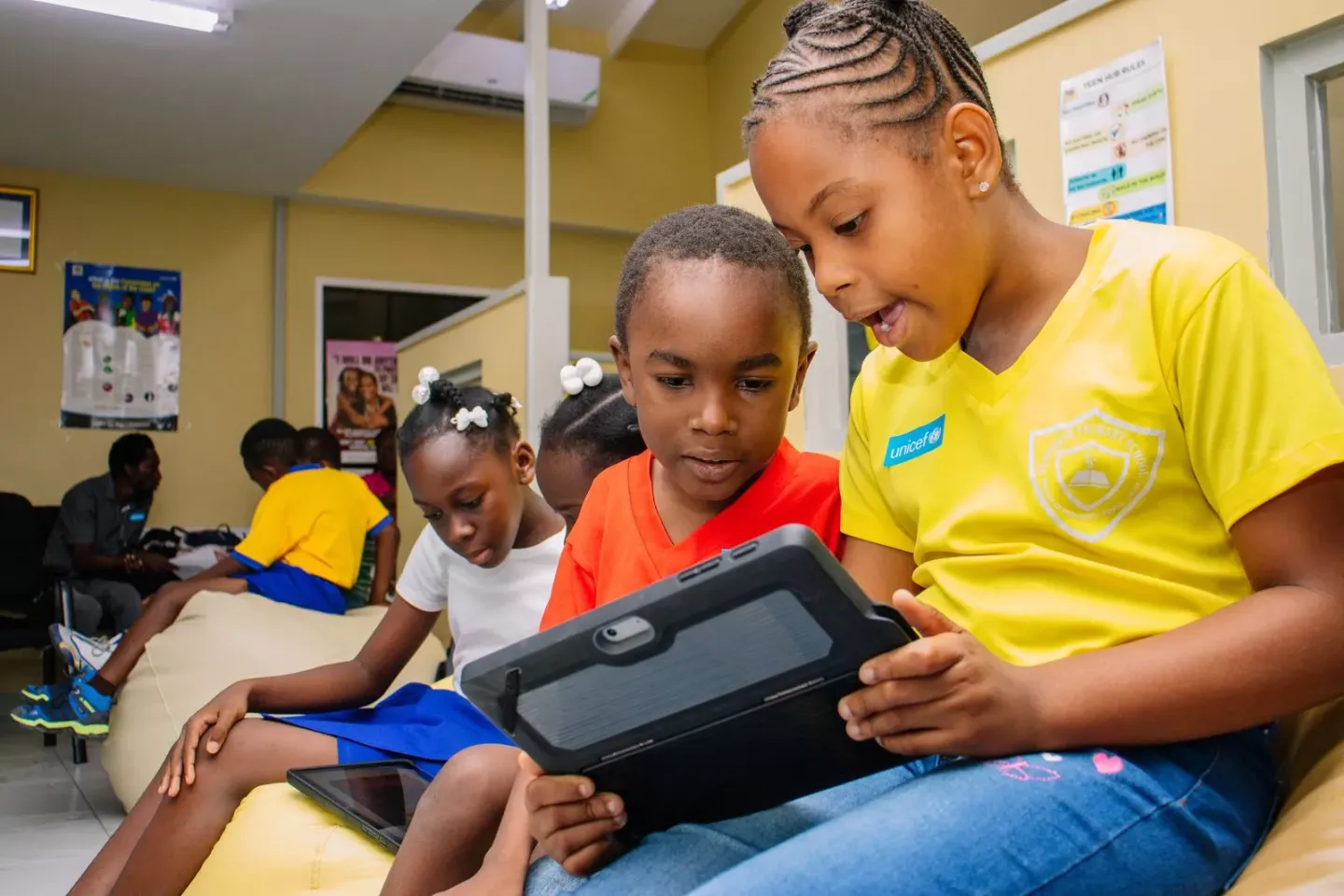 Children in Jamaica on a tablet 
