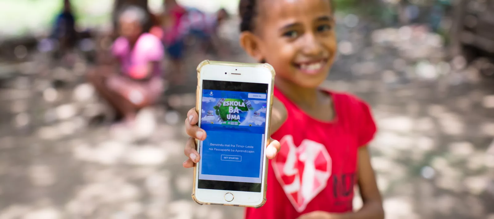 A girl shows off the Learning Passport via a mobile app.