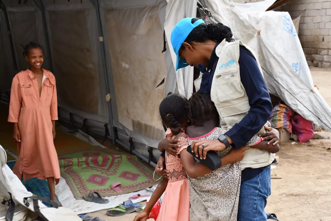 UNICEF staff embracing children